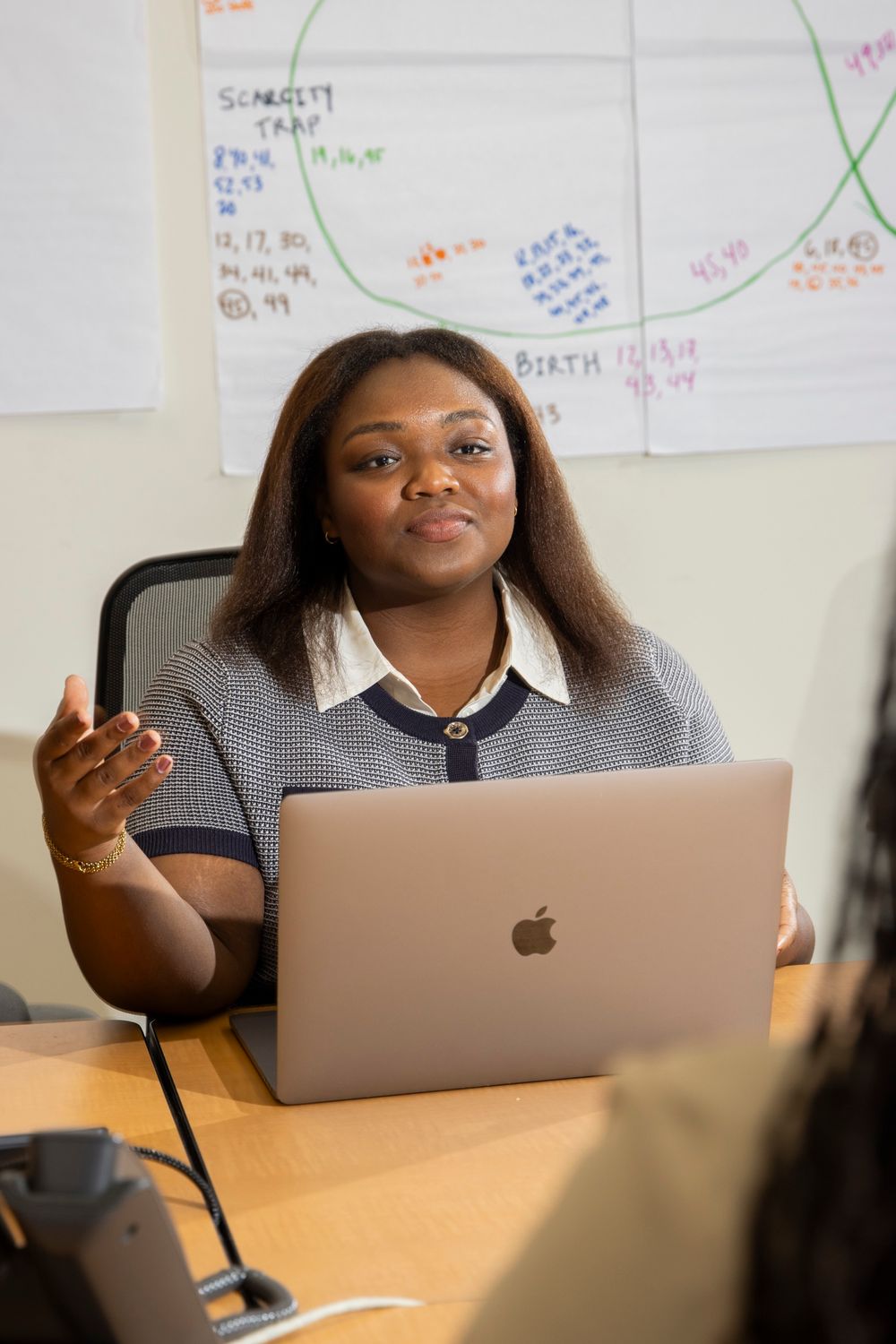 Camille Cash talking through a website plan with a client at her laptop